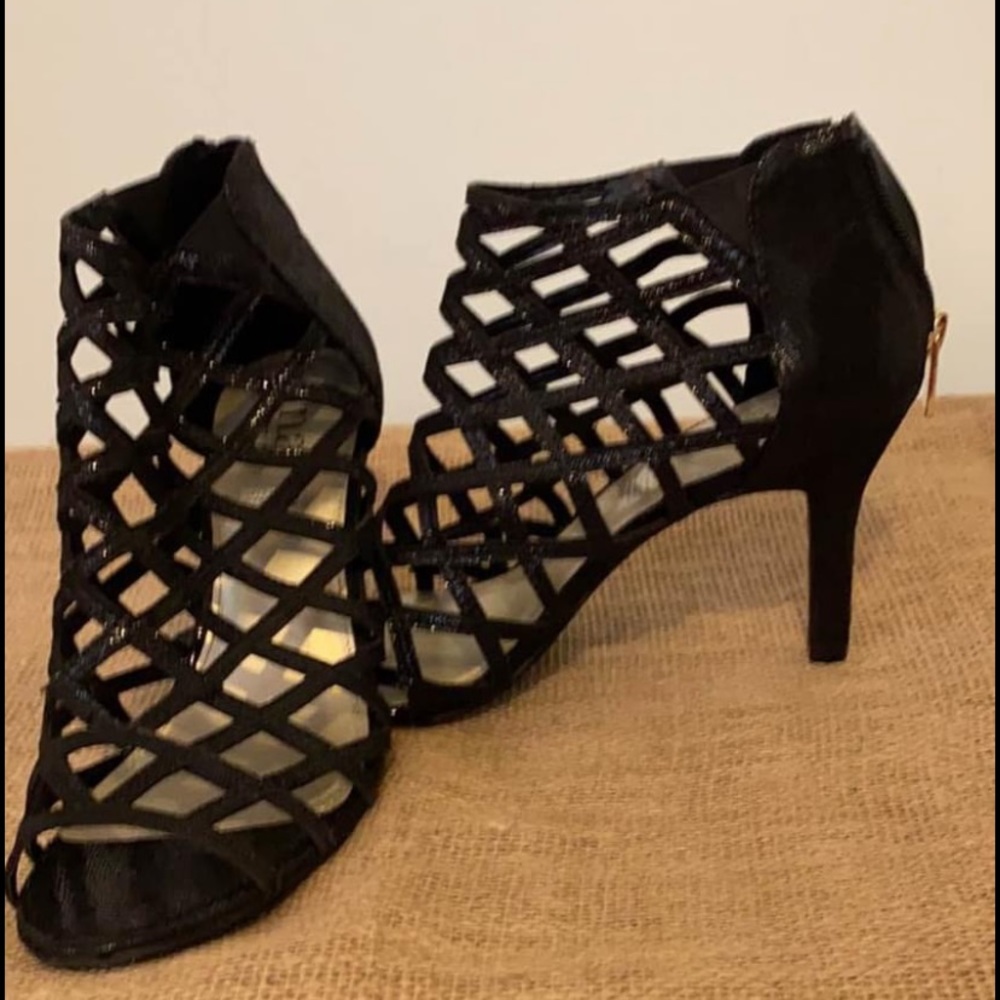 Black lattice heels. Back zipper and open toed.